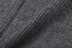 Close-up of dark grey ribbed knit fabric texture detailing for women's cardigan