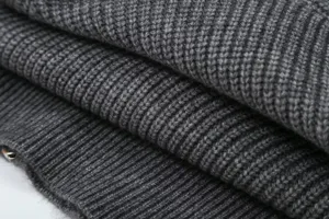 Dark grey ribbed knit sweater fabric detail macro shot, soft texture cardigan material.