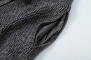 Dark grey knit cardigan pocket detail, soft knitted texture fabric close-up view for women.