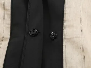 Close-up detail of new Chinese style contrast color top, featuring black snap button and fabric.