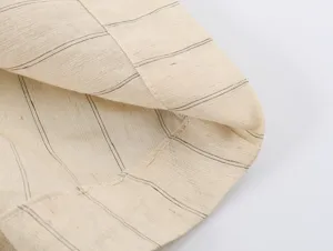 Detailed view of the striped fabric with neat stitching, showing fine texture and quality.