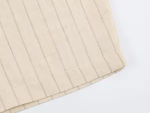 Close-up fabric detail of striped women apparel, showing fine texture and neat stitching hemline.
