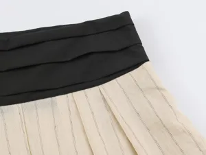 Close-up detail of women's Chinese-style color-block wide waistband and striped pleated fabric.