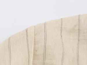 Close-up fabric detail of linen blend material featuring fine vertical stripes for apparel.