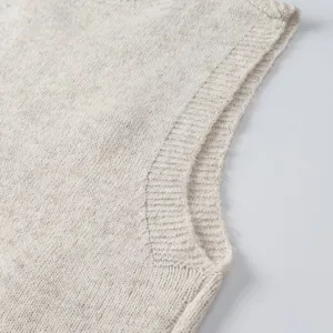 Vista detallada de chaleco de punto beige con canalé fino y textura suave otoño.