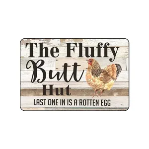 Vintage metal tin sign with funny chicken design and rustic wood background for farm decor.
