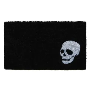 Detailed view of the black doormat featuring a striking white skull graphic for decor.