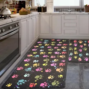 Kitchen floor mat detail featuring colorful paw prints on dark anti-slip surface for home use.