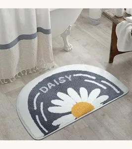 Close-up detail of the semi-circular plush bathroom mat with daisy flower pattern.