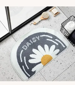Semi-circular cashmere-like bath mat with daisy pattern, absorbent floor rug for bathroom.