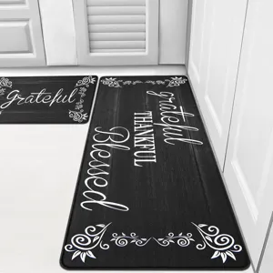 Set of two black wood grain kitchen floor mats with grateful thankful blessed text design.
