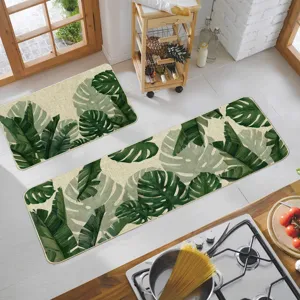Lot de 2 tapis de cuisine antidérapants et lavables avec motif de feuilles de monstera tropicales.