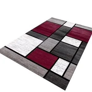 Modern geometric pattern area rug with black white gray and red color block design for home