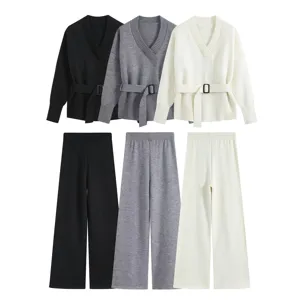 Detailed view of the knit sweater and wide-leg trousers set featuring a V-neck and belt.