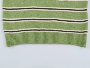 Close-up detail view showing the green striped knit sweater hem and soft fabric texture.