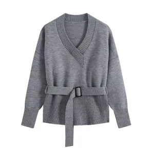 Grey V-neck knit sweater detail, showcasing a stylish black buckle waist belt and chic sleeves.