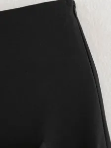 Black skirt fabric detail showing smooth texture and side zipper design for women.