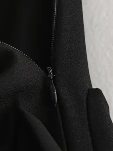 Close-up view of black fabric texture and zipper detail on stylish women skirt apparel.