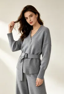 Detailed close-up shot of the elegant grey knitted V-neck top and pants set featuring a chic belt.