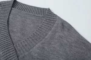 Grey knit sweater detail shot, V-neck ribbed collar, fine texture for women autumn.