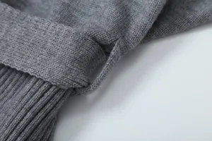 Close-up detail view of grey knit garment waistband and exquisite ribbed texture craft.