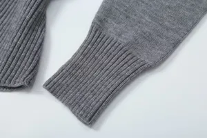 Detailed close-up view of the grey women's knit sweater ribbed sleeve cuff texture.