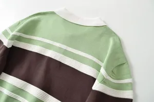 Detail view of women contrast striped polo collar knit sweater showing texture and knit.