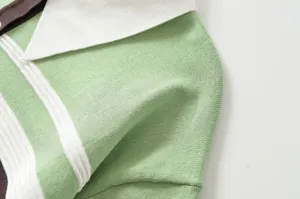 Close-up of green and white striped knit polo shirt collar showing fine fabric texture.