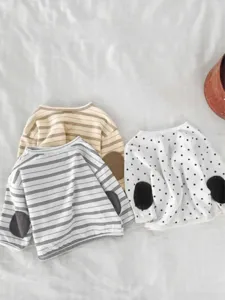 Detail view of casual children long sleeve t-shirts featuring cute elbow patches and striped patterns.