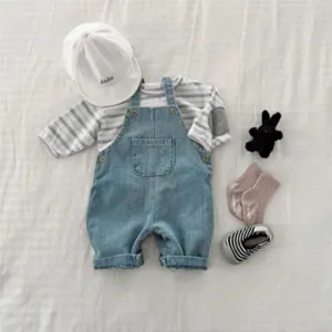 Detailed flat lay view of infant striped long sleeve t-shirt and denim overalls set.