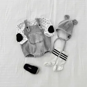 Detail view of baby knit romper, dotted long-sleeve top, bear ear hat and striped socks set.