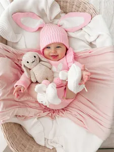 Cute baby pink knit romper set with rabbit ear hat and plush toy for autumn winter detail
