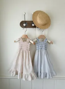 Close up details of the baby girl summer sleeveless smocked strap dress with cute ruffles.