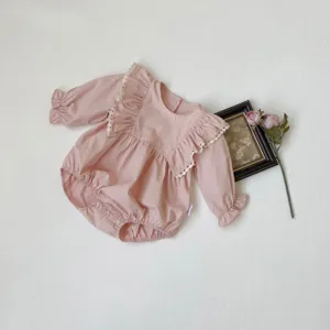 Cute baby girl long-sleeve pink romper with large lace ruffles and snap buttons for spring.