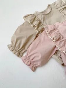 Infant long sleeve ruffle romper detail showing cute lace trim and soft cotton fabric texture.