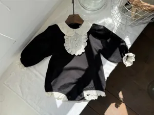 Charming infant baby girl black romper featuring white lace collar and exquisite pearl buttons.