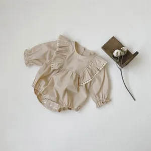 Detailed view of baby girl long sleeve romper, cute ruffles and delicate lace trim design.