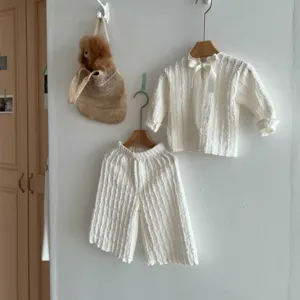 Baby girl white long sleeve top and wide leg pants set with bow detail, cute spring autumn outfit.