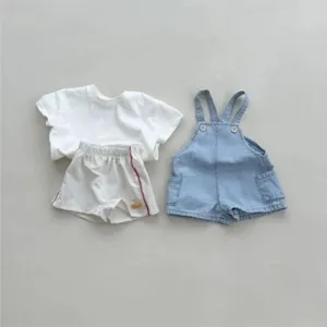 Detailed view of children casual clothing set, featuring white t-shirt and denim bib shorts.