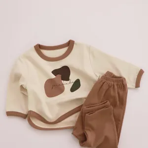 Cozy cotton children clothing set featuring color block design and abstract graphic top for autumn.