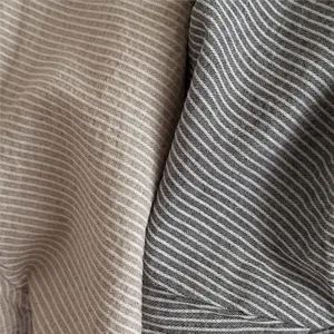 Close up fabric detail of vintage striped cotton casual pants for kids, soft and comfy.