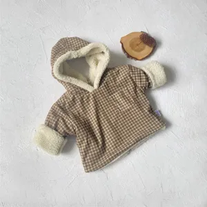 Close-up of brown plaid infant jacket with cozy white sherpa hood and fleece lining details.