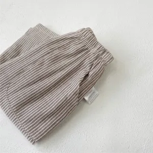 Cotton striped baby casual pants detail shot, soft infant trousers with elastic waist.