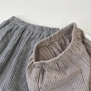 Detailed view of children's cotton casual pants featuring striped and grid patterns.