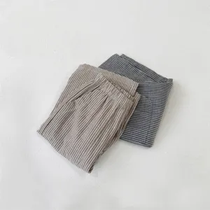 Infant casual pants detail showing folded soft pure cotton vintage striped fabric texture.