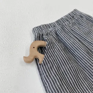 Kids cotton striped casual pants detail shot, baby retro long trousers with pocket decoration.
