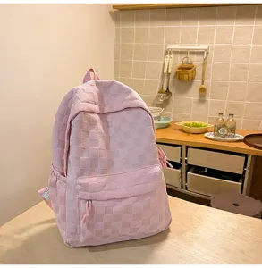 Pink checkered backpack detail view, large capacity casual school bag for daily use.