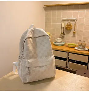 Detailed view of casual beige checkered backpack, large capacity school bag for daily use.