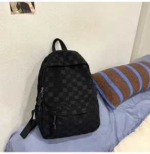 Black checkered backpack detail showcasing casual student style, spacious and durable.