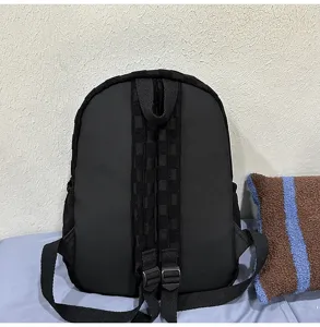 Casual black backpack for women and students, large capacity simple daypack with grid strap.